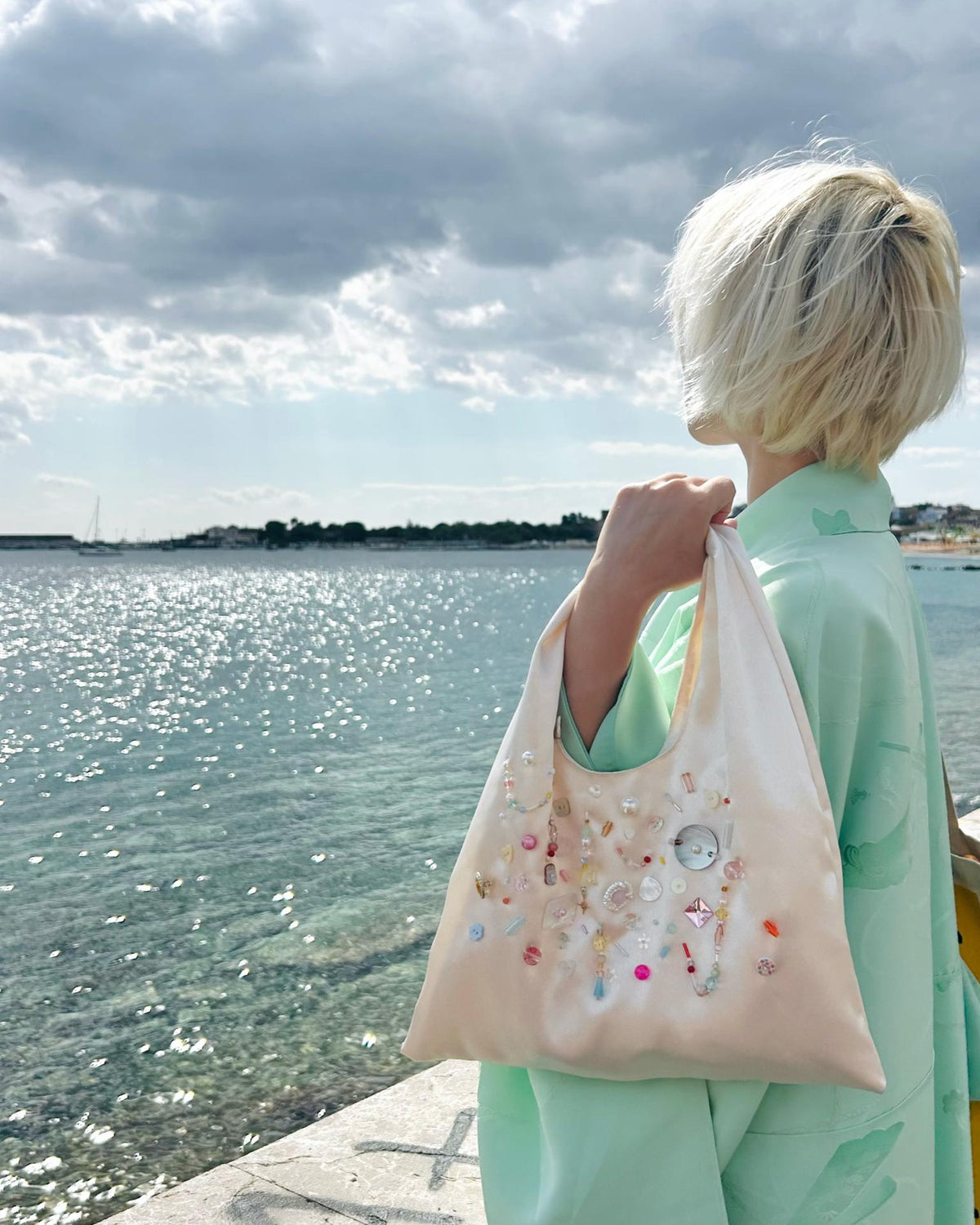 Champagne satin beaded triangle bag, styled seaside